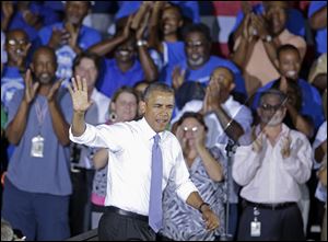 President Barack Obama waves  as he arrives to speak about the economy today at the Jacksonville Port Authority in Jacksonville, Fla. 