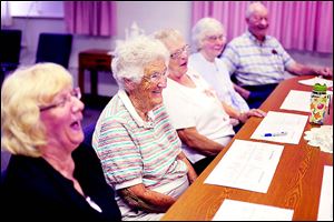From left: Marie Brewer laughs along with Rosann Murray, Lois Heminger, Carol Cook, and Michael Seery while talking about the history of First St. Mark’s Lutheran Church in Oregon.