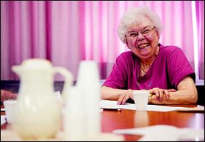 Oregon resident Bonnie Lutzmann joins in the laughter while talking about the church’s history.