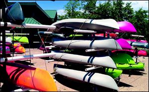 Racks of kayaks ready for sale fill the courtyard in front of Cabela’s in Dundee.