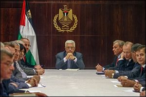 President Mahmoud Abbas, center, chairs a Palestinian cabinet session. He refused to engage in peace talks until Israel agreed to release 104 Palestinian prisoners.