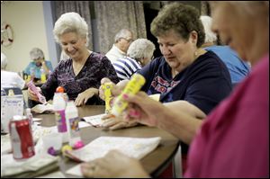 Katie Vaughan of Toledo, left, Eunice Block, and Sue Jones, both of Oregon, play bingo at the James ‘Wes’ Hancock Senior Center on Bayshore Road.  About 285 seniors use the facility each week.
