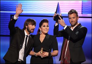 Dave Haywood, from left, Hillary Scott and Charles Kelley, left to right, from the band Lady Antebellum accept the award for favorite band, duo or group - country at the 40th Anniversary American Music Awards.