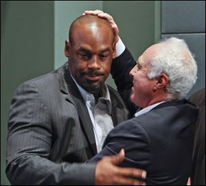 Six-time Pro Bowl quarterback Donovan McNabb, left,  and Philadelphia Eagles owner Jeffrey Lurie embrace before a news conference today in Philadelphia.