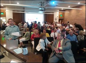 Residents pack the Perrysburg City Council meeting that discussed the proposed $26 million riverfront park on July 30, 2013.