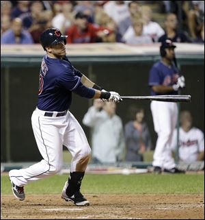 Cleveland's Yan Gomes hits a two-RBI double off Chicago White Sox reliever Matt Lindstrom in the eighth inning Tuesday night. The Indians rallied to win 7-4.