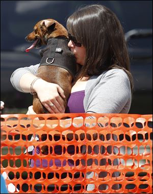 Erynne Hunt kisses her dog Fritz.