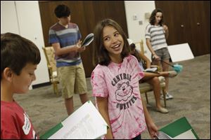Megan Dona, 10, center, laughs while she acts with her fellow campers during a practice of a play version of the Emperors New Clothes.