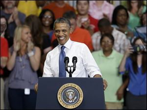 President Obama reacts to the greeting he is given before speaking at an Amazon distribution center, today, in Chattanooga, Tenn. 