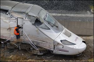 A rail personnel worker checks the cabin of a derailed train following an accident in Santiago de Compostela, Spain last Thursday.