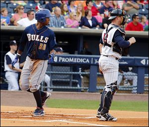 Durham's Tim Beckham scores behind Mud Hens catcher Bryan Holaday in the first inning Tuesday at Fifth Third Field.