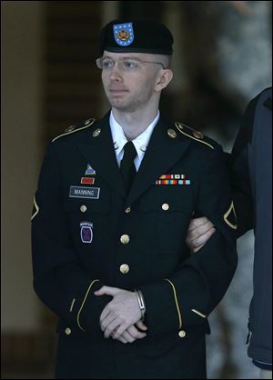 Army Pfc. Bradley Manning is escorted to a security vehicle outside of a courthouse in Fort Meade, Md., today after the third day of deliberations in his court martial.
