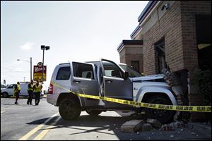 Toledo police and fire departments investigate an accident in which a silver Jeep Liberty crashed through the drive-through window of a Wendy's restaurant at approximately at 1859 W. Laskey Road. 