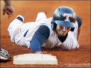 Toledo’s Ben Guez dives safely back to first on a pick off attempt by Durham Bulls pitcher J.D. Martin in the third inning. The Mud Hens lost their fourth straight game Thursday night.