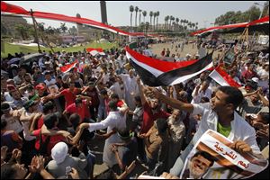 Supporters of Egypt's ousted President Mohammed Morsi shout slogans and hold his posters during a rally at a camp near Cairo University in Giza, southwest of Cairo.