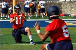 Freshman quarterback Logan Woodside (11) warms up with freshman quarterback Michael Julian (5) during practice.