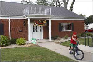 DJ Duquette, 9, rides home after visiting the Deerfield Branch Library, part of the Lenawee District Library, in Deerfield.