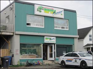 Royal Canadian Mounted Police work at the scene of a fatal python attack at Reptile Ocean exotic pet store in Campbellton, New Brunswick.