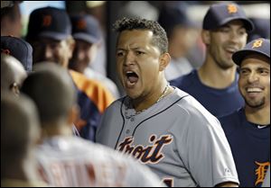 Detroit Tigers' Miguel Cabrera celebrates in the dugout after the Tigers take the lead on a three-run home run by Alex Avila.