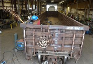 Anthony Cieply grinds a weld at The Andersons’ rail-car repair facility in Maumee. The Rail Group saw record growth in 2012. 