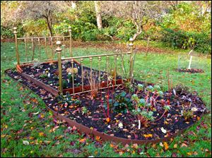 This is a garden where the gardener found a creative way to showcase a flower bed using a bed frame.