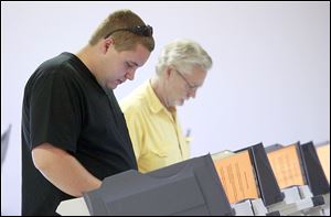 Richard Richie, left, and Michael Richie of Swanton vote during a special election on Tuesday at the American Legion building.