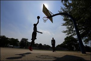 Casaun Anderson and Montrece Collins shoot hoops at Friendship Park in Point Place.