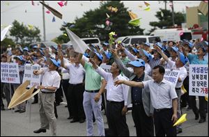 South Korean owners who run factories in the stalled South Korea and North Korea's joint Kaesong Industrial Complex and workers throw paper airplanes during a rally at the Imjingak Pavilion near the border village of Panmunjom today.