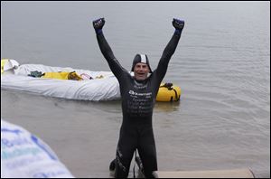 Swimmer Jim Dreyer celebrates reaching Detroit after a 51-hour swim.