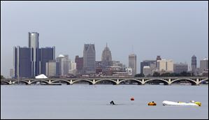 Jim Dreyer, a long-distance swimmer, arrives at Belle Isle in Detroit, today. Dreyer took off from the Clinton River Boat Club in Clay Township, Mich., on Monday to swim 22 miles across Lake St. Clair while hauling dinghies filled with 2,000 pounds of bricks. 