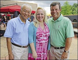 Do Nguyen, Julie Abbey, and Fred Grimm attend the D.O.V.E. event at the Pinnacle in Maumee.