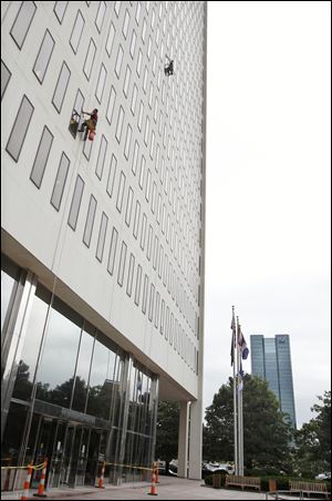 Clearview Cleaning Contractors LLC of Cleveland, scale the facade of the One Government Center.