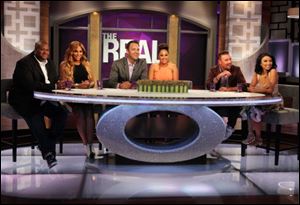Hosts Tamar Braxton, second left, with husband, Vincent Herbert, left, Tamera Mowry-Housley, center, with husband, Adam Housley, and Jeannie Mai with husband Freddy Harteis, on the set of 'The Real.' 