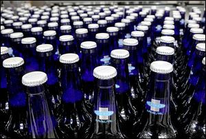 Bottles of Bud Light Platinum move along during the packaging process at an Anheuser-Busch brewery, where the firm has taken risks with new products.