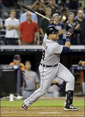 The Tigers' Miguel Cabrera follows through on a two-run home run during the ninth inning to tie the game.