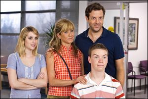 From left, Emma Roberts, Jennifer Aniston, Jason Sudeikis, background right, and Will Poulter in a scene from 'We're the Millers.'