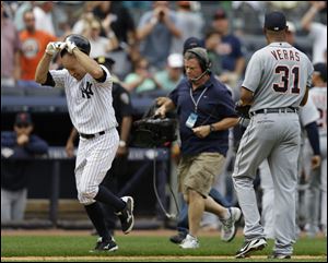 New York's Brett Gardner, left, passes Detroit Tigers reliever Jose Veras after hitting a ninth-inning solo home run to lift the Yankees to a 5-4 victory on Sunday.