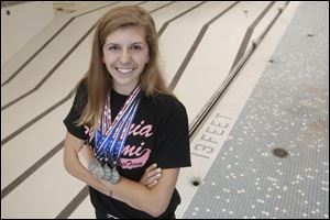 Lauren Sullivan of Lambertville shows some of the medals she won at separate competitions in July and August. The accomplished backstroke swimmer looks forward to swimming with the team at Bedford High School, where she will start as a freshman in the fall.