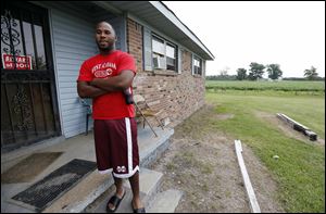 In this July 30, 2013 photograph, Perry Turner, 21, who lives across the road from the planned site for GreenTech Automotive's Tunica, Miss., assembly  facility, said there was a lot of talk about the new car company years ago in the county of about 11,000 people south of Memphis, Tenn. But that talk has faded and Perry said there has been little activity at the site until recent months.