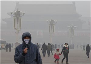 A man wears a mask on Tiananmen Square in thick haze in Beijing in January. China, one of the most visited countries in the world, has seen sharply fewer tourists this year, with worsening air pollution partly to blame.