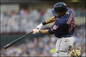 Cleveland Indians' Michael Brantley follows through with an RBI single off Minnesota Twins pitcher Samuel Deduno in the fourth inning.