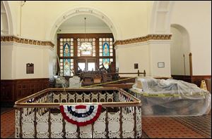Furniture from Courtroom 1 is protected by plastic in the hallway during a restoration project on the third floor of the Hancock County Courthouse.