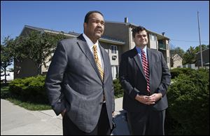 Former Toledo Mayor and Toledo City Council candidate Jack Ford, left, makes 'a public call to action' at the Greenbelt Place Apartments. He is joined by Joe McNamara, Toledo City Council member and Toledo mayoral candidate, right.