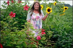 Cheryl Metro offers motorists a scenic drive with a roadside garden that stretches more than two football fields along County Road 8-1 in Fulton County.