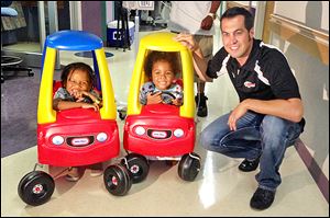 Indy and NASCAR driver Sam Hornish, Jr., visited Mercy Children's Hospital in Defiance. Here he is with Maurice and Mirah Carlton. Mirah visits Mercy occasionally to be treated for Sickle Cell Anemia. 