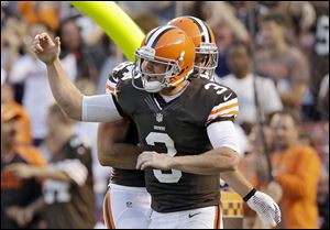 Cleveland Browns quarterback Brandon Weeden celebrates after tossing a first-quarter TD pass.