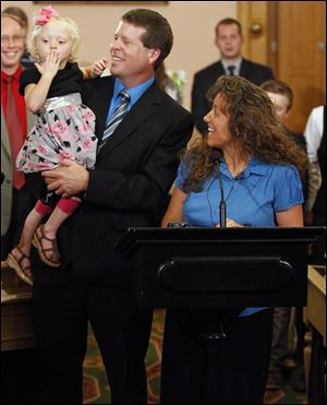 Michelle Duggar speaks about her youngest child, Josie, who is being held by her father, Jim Bob, at a news conference that announced the resurrection of the anti-abortion rights heartbeat bill, at the Statehouse in Columbus.