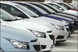 A line of 2012 Chevrolet Cruze sedans sit at a dealership in the south Denver suburb of Englewood, Colo