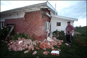 Kieran Hickman surveys the damage to his property at Taimate, New Zealand after a 6.5 magnitude trembler.