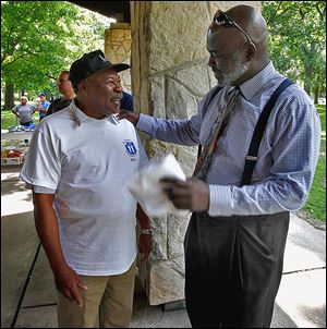 Toledoan Joe Smith, left, talks with Toledo Mayor Mike Bell at a Block Watch event at Ottawa Park.